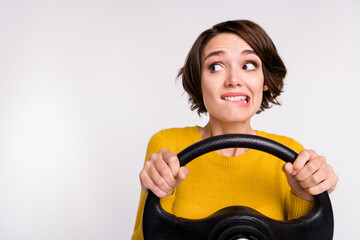 Photo of cunning brunette young lady look empty space drive wear yellow shirt isolated on grey...