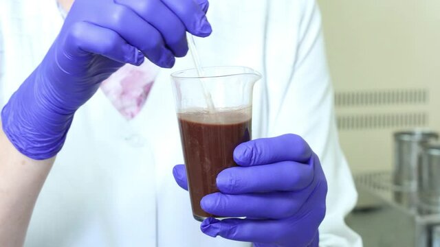 the laboratory assistant checks the products of the food factory for composition and quality