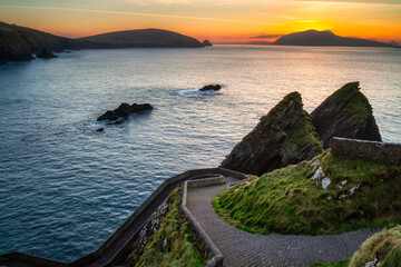 Amazing sunset over the Atlantic Ocean in the Dunquin Pier on Dingle Peninsula, County Kerry,...