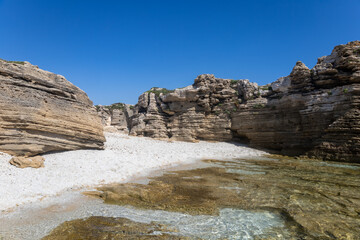 Fototapeta na wymiar Is Arutas beach with turquoise sea and quartz sand grains similar to grains of rice. Sinis Peninsula, Cabras, Oristano, Sardinia, Italy