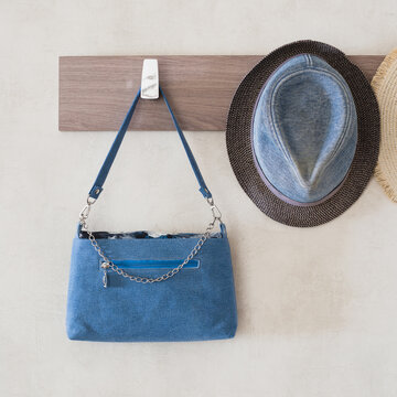 Denim Hat And Denim Women Bag On The Hook Of The Hanger In The Hallway