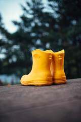 A pair of rubber yellow boots for rainy weather - the onset of the rainy season in autumn