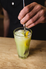 Professional cocktails with ice, lemon and alcohol - refreshing soft drinks from the bartender - the art of mixing liquids