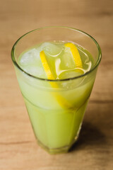 Professional cocktails with ice, lemon and alcohol - refreshing soft drinks from the bartender - the art of mixing liquids