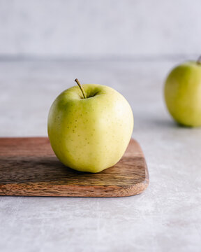 Golden delicious apple on a chopping board