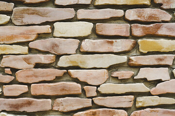 A stone wall. The texture of a large stone. Part of a building wall. Close-up. Copy space.