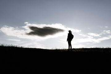 Silhouette man and woman in the mountains and hiking.