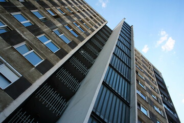 Block of flats with blue sky and clouds, urban building, real estate concept. Council tower block. Expensive prices for flats and apartments in the city.