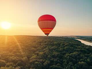 Flying balloon over the forest on a background of sky