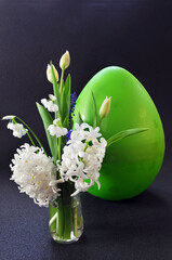 Easter greeting card with white flowers and a huge Easter egg, free space for your text