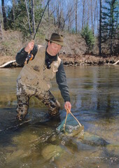 Anger netting a brown trout 