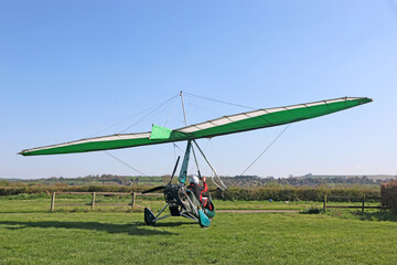 Obraz na płótnie Canvas Ultralight airplane on a grass airfield 