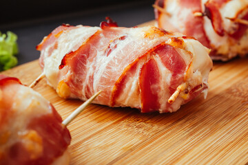 Baked chicken wrapped in bacon. Delicious appetizer with crispy smoked bacon. Chicken breast...