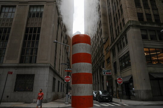 A person walks by a steam pipe in the Financial District after The United Nations released the Intergovernmental Panel on Climate Change's (IPCC) latest report, in Manhattan, New York City