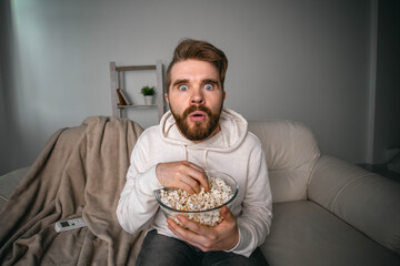 Portrait of guy watching TV series online. Online cinema and video streaming service concept.