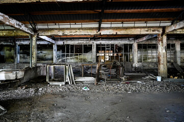 Old and abandoned industrial complex. Interior of former factory. Ruined warehouse hall. 