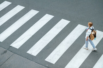 pupil crossing crosswalk and going to school outdoors in city