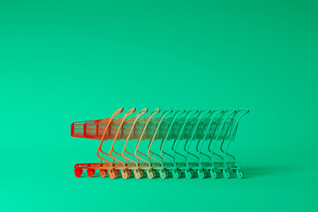 Minimal composition for shopping and supermarket concept. Gradient Red and green gradient shopping cart trolley on green background. 3d rendering illustration. Clipping path of each element included.