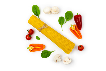A bunch of spaghetti with vegetables and herbs on a white plate. Tomatoes, mushrooms, peppers and spinach. Ingredients for making Italian pasta. Top view