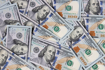 Background of hundred-dollar bills. The texture of hundred-dollar bills. A lot of dollars