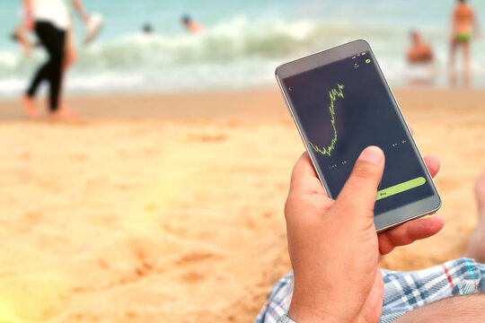 Man holding a mobile phone. internet connection on the beach