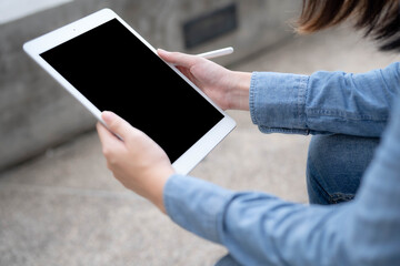 Close-up photo of female hands working with tablet computer. Woman using social network