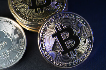 Gold and Silver Bitcoin coins on dark background