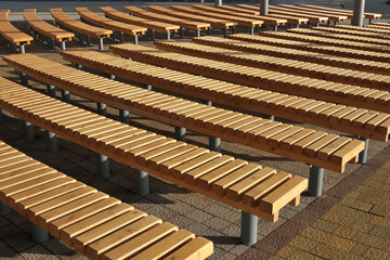 Wooden benches without backrest on the street  as  background