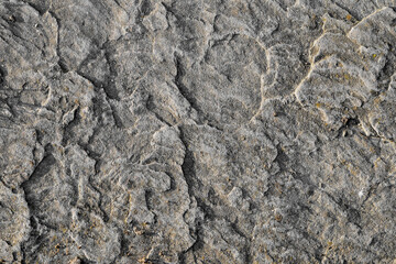   Abstract background. Grey sandstone texture. Natural stone background. Surface of a stone wall of an old house . Polished sandstone surface.  Solid construction material.