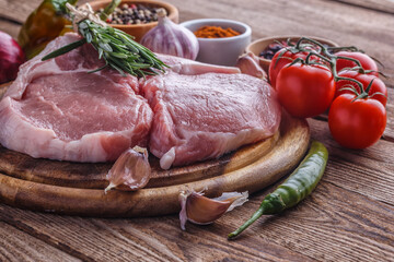 fresh raw new-york steak on wooden Board on wooden background with salt and pepper in a rustic style.