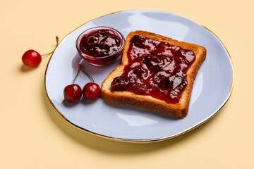 Bowl and toast with cherry jam on color background