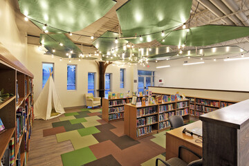 Interior of school children's library with colorful books and carpet