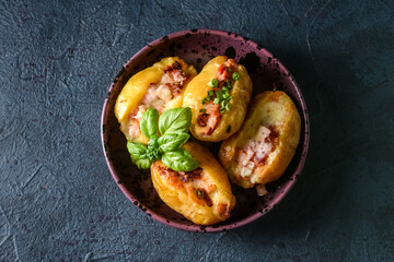 Plate with baked potato on dark background