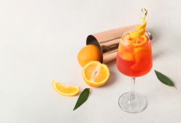 Glass of Aperol spritz cocktail on light background
