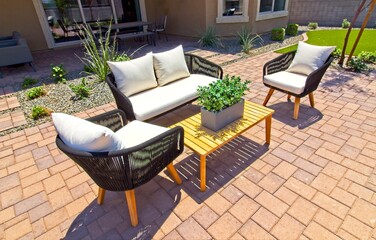 Rear Yard Patio Areas With Chairs, Couch And Tables On Red Pavers