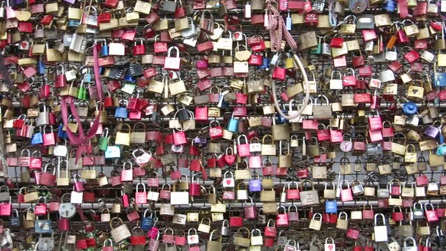 A closeup of the beautiful love locks at Hohenzollern Bridge in Cologne, Germany on a bright afternoon