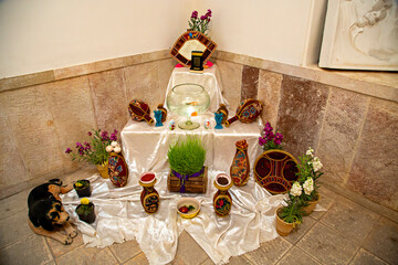 Persian New Year's Table known as Haftsin Table or Nowruz Table with at least seven items that...