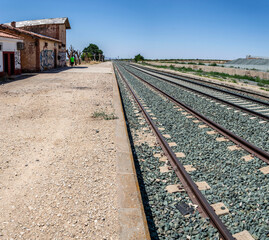 Fototapeta na wymiar Train tracks that pass through the old and abandoned La Calahorra- Ferreira train station