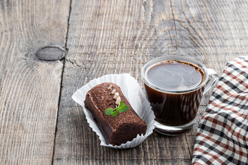 traditional Russian chocolate biscuit cake on serving board with coffee mug