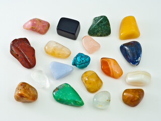 Collection of colorful polished semiprecious gemstones on white