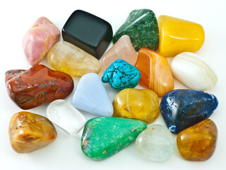 Collection of colorful polished semiprecious gemstones on white