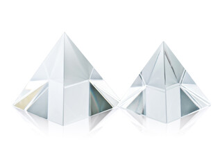 Two different size clear transparent crystal pyramids on white