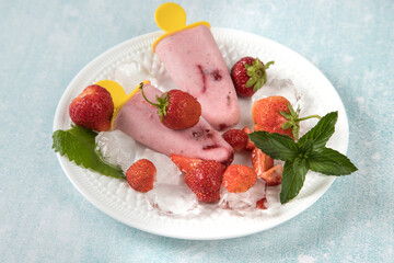 A white plate with homemade strawberry ice cream. Healthy summer desserts