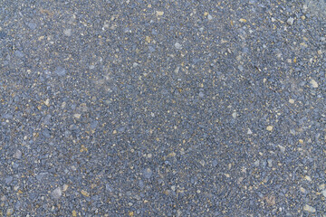 Crushed grey stone on the ground texture background.