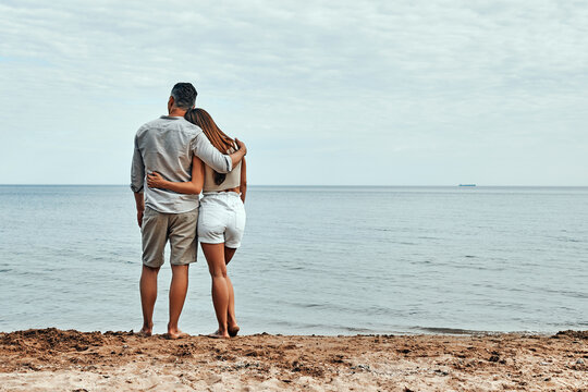 Picture of romantic young couple on the sea shore.