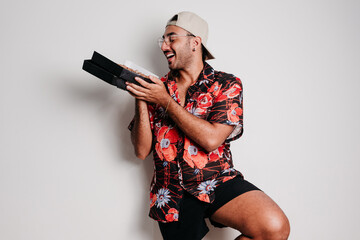 Male model with cap and glasses showing chocolate pizza.