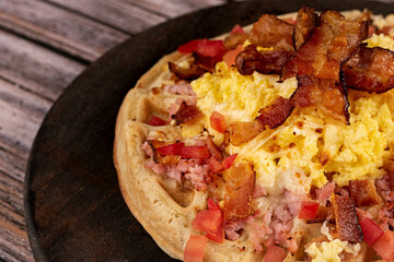 Waffle with eggs, cheese, tomato and bacon