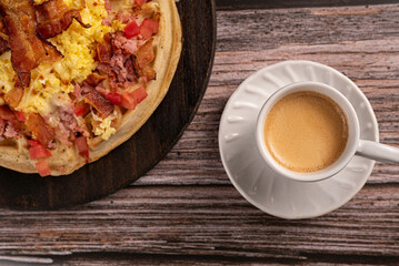 Waffle with eggs, cheese, tomato and bacon with black coffee