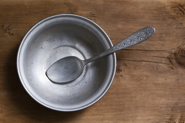 Empty aluminum bowl with spoon