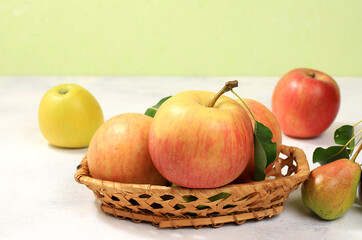 Autumn composition of apples and pears on a sunny table, thanksgiving background, harvesting, healthy natural food concept, detox diet and body cleansing, banner for screen, cafe, restaurant,